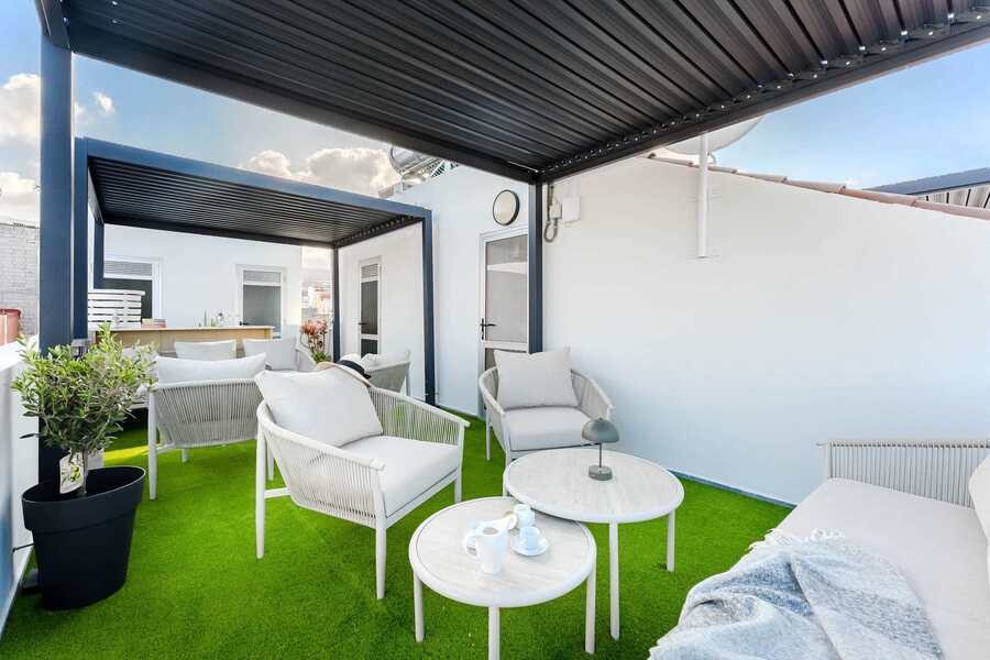 Stylish Communal Rooftop Seating Area for Relaxed Sunset Evenings