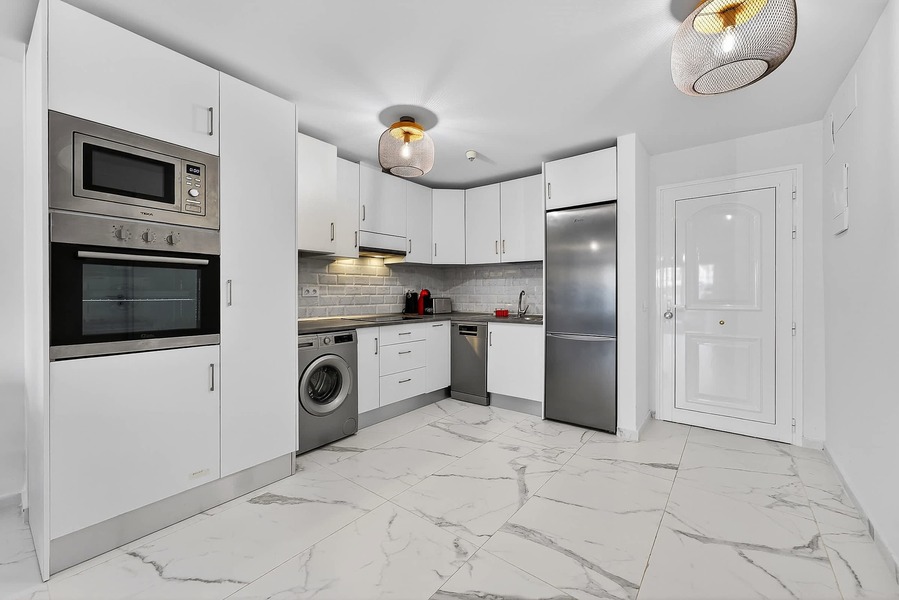 Fully Equipped Kitchen with Modern Appliances and Dining Essentials