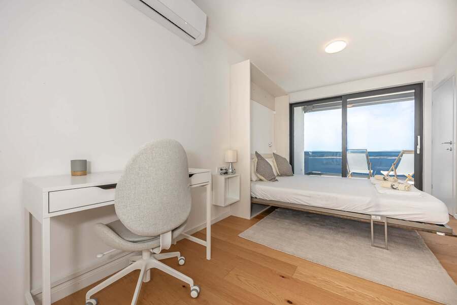 Bedroom 3 with workspace and sea view