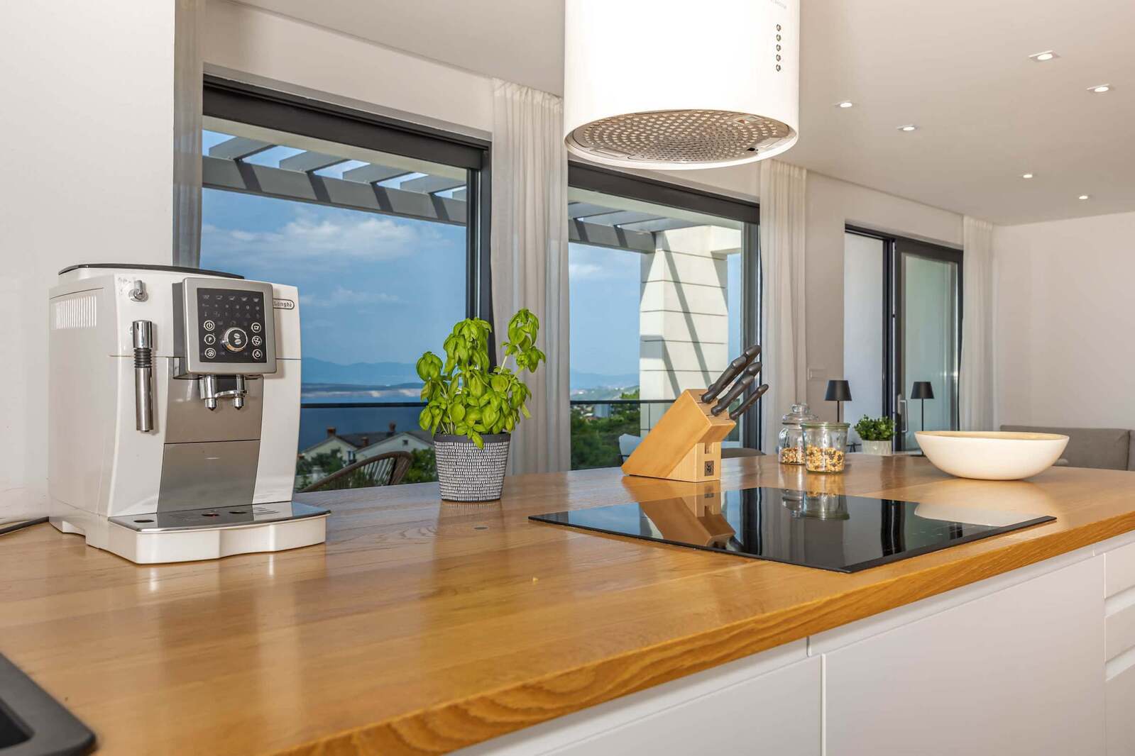 Induction hob, espresso machine and sea view from the kitchen