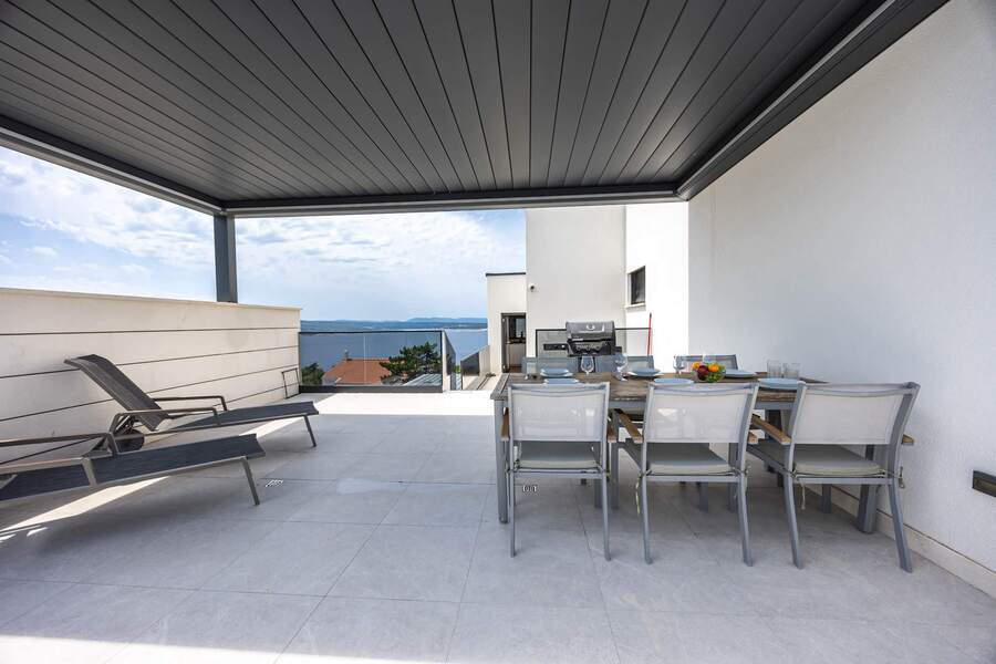 Covered pool terrace: dining for eight and loungers
