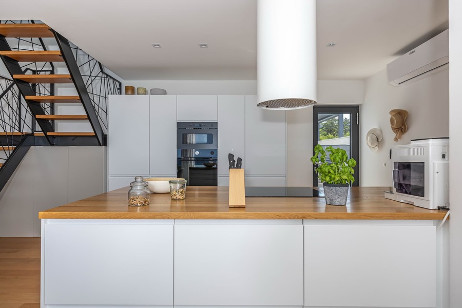 Kitchen island with oven, microwave and coffee machine