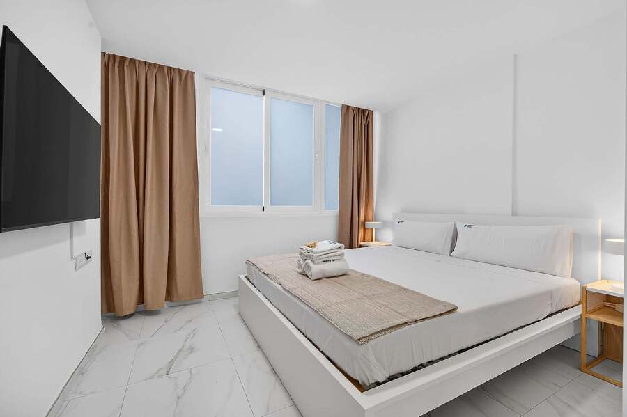 Bedroom with Smart TV & Blackout Curtains