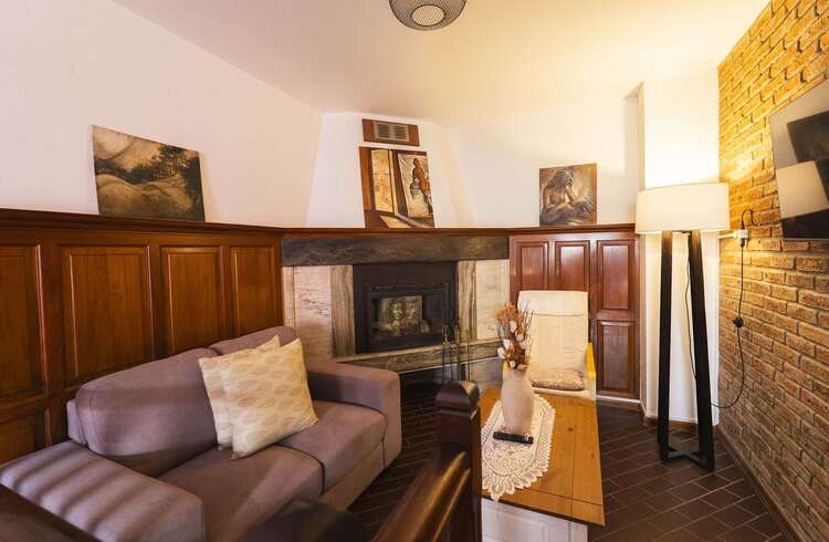 Lounge with Exposed Brick and TV