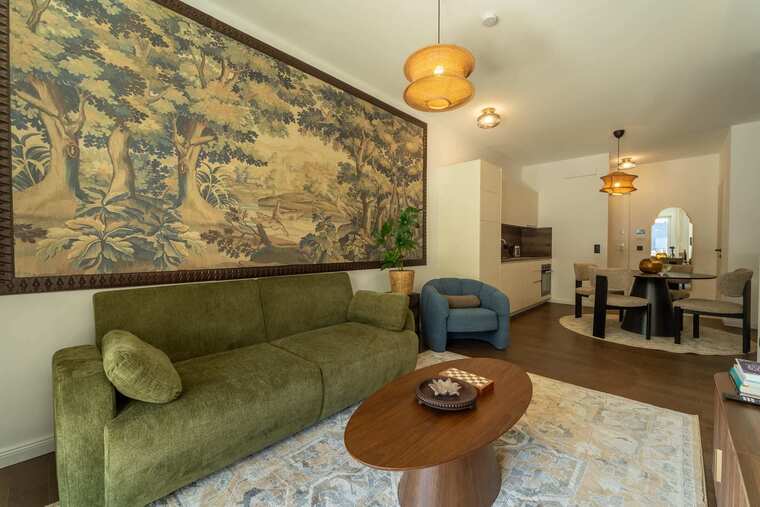 Living room with sofa bed and tapestry wall