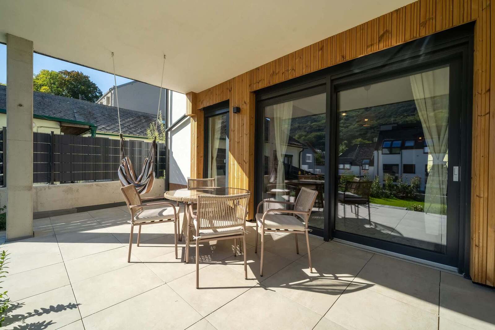 Terrace with dining set and hanging chair