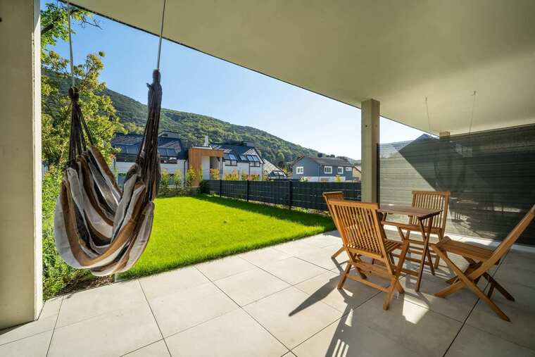Terrace with hanging chair and dining set